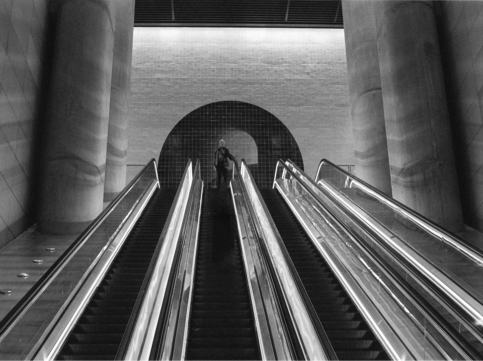 Street and urban photography — escalators descending into a subway