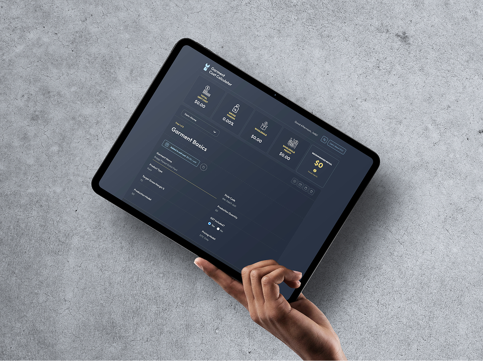 Tablet displaying an interface and typography system on a concrete surface